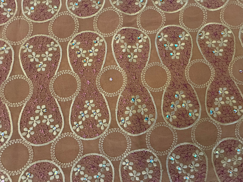 Decorative fabric with floral patterns and rhinestones on a brown background