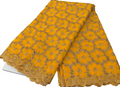 Yellow floral lace fabric on a white surface