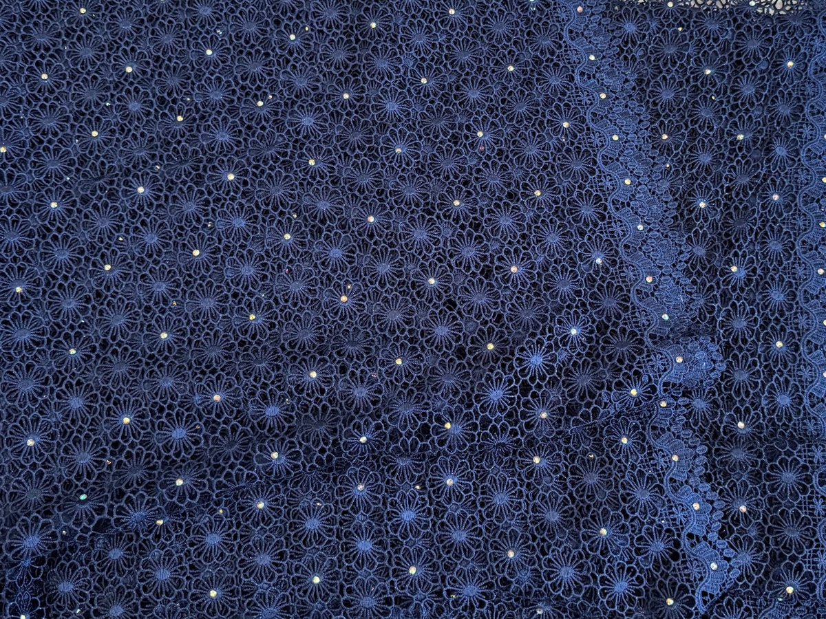 Blue lace fabric on a textured surface
